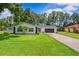 Charming single-story home features a well-manicured lawn and a stone-accented facade at 210 Lake Hobbs Rd, Lutz, FL 33548