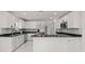 Modern kitchen with stainless steel appliances, granite countertops, and sleek white cabinetry at 210 Lake Hobbs Rd, Lutz, FL 33548