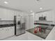 Modern kitchen featuring stainless steel appliances, granite countertops, and ample white cabinetry at 210 Lake Hobbs Rd, Lutz, FL 33548