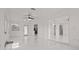 Spacious living room featuring tile flooring and bright white walls at 210 Lake Hobbs Rd, Lutz, FL 33548
