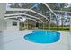 Beautiful kidney-shaped pool enclosed in a screen, perfect for outdoor relaxation at 210 Lake Hobbs Rd, Lutz, FL 33548