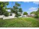 This backyard features a grassy area perfect for outdoor activities at 2149 Dixie Garden Loop, Holiday, FL 34690