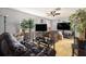 Inviting living room with hardwood floors, a ceiling fan, and bright natural lighting from the windows at 2149 Dixie Garden Loop, Holiday, FL 34690