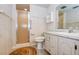 Bathroom with a glass shower, white vanity, and decorative wallpaper creating a clean, functional space at 2206 Cordova Grn # 2206, Seminole, FL 33777