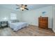 Well-lit bedroom featuring wood-look flooring, modern fan, and ample space creating a comfortable retreat at 2206 Cordova Grn # 2206, Seminole, FL 33777