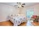 Cozy bedroom featuring a floral-patterned quilt, a ceiling fan, and a window offering natural light at 2206 Cordova Grn # 2206, Seminole, FL 33777