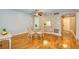 Cozy dining area featuring a glass-top table, hardwood floors, and an open view to the kitchen at 2206 Cordova Grn # 2206, Seminole, FL 33777