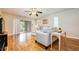 Bright living room with hardwood floors, contemporary furnishings, and sliding doors creating a seamless indoor-outdoor flow at 2206 Cordova Grn # 2206, Seminole, FL 33777