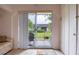 Patio with glass sliding doors overlooking garden, lounge chair, and indoor/outdoor rug at 2206 Cordova Grn # 2206, Seminole, FL 33777
