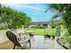Outdoor patio with seating, table and landscaped garden in a lovely yard view at 2206 Cordova Grn # 2206, Seminole, FL 33777