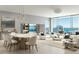 Bright, open-concept living area featuring modern decor, floor-to-ceiling windows with stunning water views, and an adjacent dining area at 235 1St S Ave # 2703, St Petersburg, FL 33701