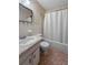 Bathroom featuring a shower and vanity with a marble counter at 2460 Persian Dr # 44, Clearwater, FL 33763