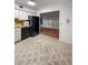 Cozy kitchen with black appliances and tiled floor overlooking the living room at 2460 Persian Dr # 44, Clearwater, FL 33763