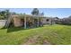 Spacious backyard with a covered patio, providing ample space for storage and outdoor activities at 2518 Keen Park Dr, Largo, FL 33771
