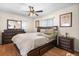 Comfortable bedroom features wood floors, ceiling fan, window, and ample storage with a dresser and nightstand at 2518 Keen Park Dr, Largo, FL 33771