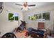 Messy room with wood floors, dual windows, and filled with boxes, and personal items at 2518 Keen Park Dr, Largo, FL 33771