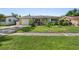 Charming single-story home featuring a well-manicured lawn and lush landscaping at 2518 Keen Park Dr, Largo, FL 33771
