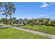 Inviting single-story home with a tidy front lawn, mature palm trees, and lush garden at 2518 Keen Park Dr, Largo, FL 33771