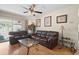 Comfortable living room boasts hardwood floors, ceiling fan, and sliding door to the backyard at 2518 Keen Park Dr, Largo, FL 33771
