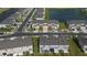 Aerial shot of community featuring townhomes along a lake, sidewalks and lush green lawns at 34196 Polacca Ln, Wesley Chapel, FL 33543