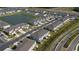An aerial view of townhomes and a central pond creating a visually appealing community at 34196 Polacca Ln, Wesley Chapel, FL 33543