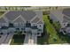 Up-close overhead shot of townhomes featuring neat landscaping, sidewalks, and private driveways at 34196 Polacca Ln, Wesley Chapel, FL 33543
