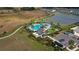 Aerial view of community pool and amenity center with lush landscaping, lake, and walking path at 34196 Polacca Ln, Wesley Chapel, FL 33543