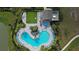 Overhead shot of community pool featuring seating, landscaping, grass lawn and pergola at 34196 Polacca Ln, Wesley Chapel, FL 33543