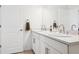 Bright bathroom with a double sink vanity, a large mirror, and white cabinets at 34196 Polacca Ln, Wesley Chapel, FL 33543