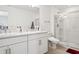 Bright bathroom features a double sink vanity, large mirror, and a glass door shower enclosure at 34196 Polacca Ln, Wesley Chapel, FL 33543