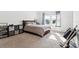 A spacious bedroom with carpet, a window providing natural light, and a dark wood bedframe at 34196 Polacca Ln, Wesley Chapel, FL 33543