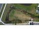 Aerial view of community dog park with lush greenery, walking trail and convenient parking at 34196 Polacca Ln, Wesley Chapel, FL 33543