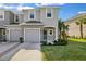 Charming two-story townhouse with a well-manicured lawn and beautiful landscaping at 34196 Polacca Ln, Wesley Chapel, FL 33543