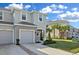Exterior view of townhouse featuring well-maintained landscaping, sidewalks, and a neatly kept lawn at 34196 Polacca Ln, Wesley Chapel, FL 33543