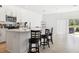 Bright, modern kitchen with stainless appliances, white cabinets, and breakfast bar seating area at 34196 Polacca Ln, Wesley Chapel, FL 33543