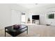 Living room with neutral colors, sliding glass doors to a patio, and modern decor at 34196 Polacca Ln, Wesley Chapel, FL 33543