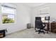 Bright office features a large window with natural light, desk, chair and neutral carpet flooring at 34196 Polacca Ln, Wesley Chapel, FL 33543