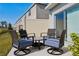 Cozy patio with seating area perfect for outdoor relaxation and entertaining with four chairs and a table at 34196 Polacca Ln, Wesley Chapel, FL 33543