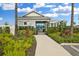Charming pool entrance with a lush landscaped walkway, inviting visitors to enjoy the community's amenities and pool at 34196 Polacca Ln, Wesley Chapel, FL 33543