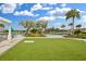 Inviting community pool area with ample seating, lush landscaping, and a pristine lawn for outdoor enjoyment and relaxation at 34196 Polacca Ln, Wesley Chapel, FL 33543