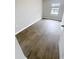 Bedroom with wood-look floors, a window, and neutral paint at 3926 Cat Mint St, Tampa, FL 33619
