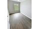 Bright bedroom featuring wood-look flooring and a window at 3926 Cat Mint St, Tampa, FL 33619