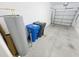 Spacious garage featuring epoxy flooring, water heater, and garage door opener at 3926 Cat Mint St, Tampa, FL 33619
