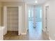 Bright hallway with multiple doors, closet, and wood-look flooring at 3926 Cat Mint St, Tampa, FL 33619