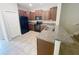 Well-lit kitchen with granite countertops, dark wood cabinets, and black appliances at 3926 Cat Mint St, Tampa, FL 33619