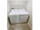 Laundry room featuring a new, white, front-load washer and dryer at 3926 Cat Mint St, Tampa, FL 33619
