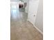 Open-concept living room featuring tile flooring, lots of natural light, and seamless flow to the kitchen at 3926 Cat Mint St, Tampa, FL 33619