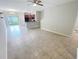 Open-concept living room featuring tile flooring, lots of natural light, and seamless flow to the kitchen at 3926 Cat Mint St, Tampa, FL 33619