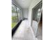 View of a screened in porch with sliding door to the interior at 3926 Cat Mint St, Tampa, FL 33619