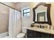 Cozy bathroom featuring a granite vanity, framed mirror, decorative tile and a tub with shower at 4012 W Obispo St, Tampa, FL 33629
